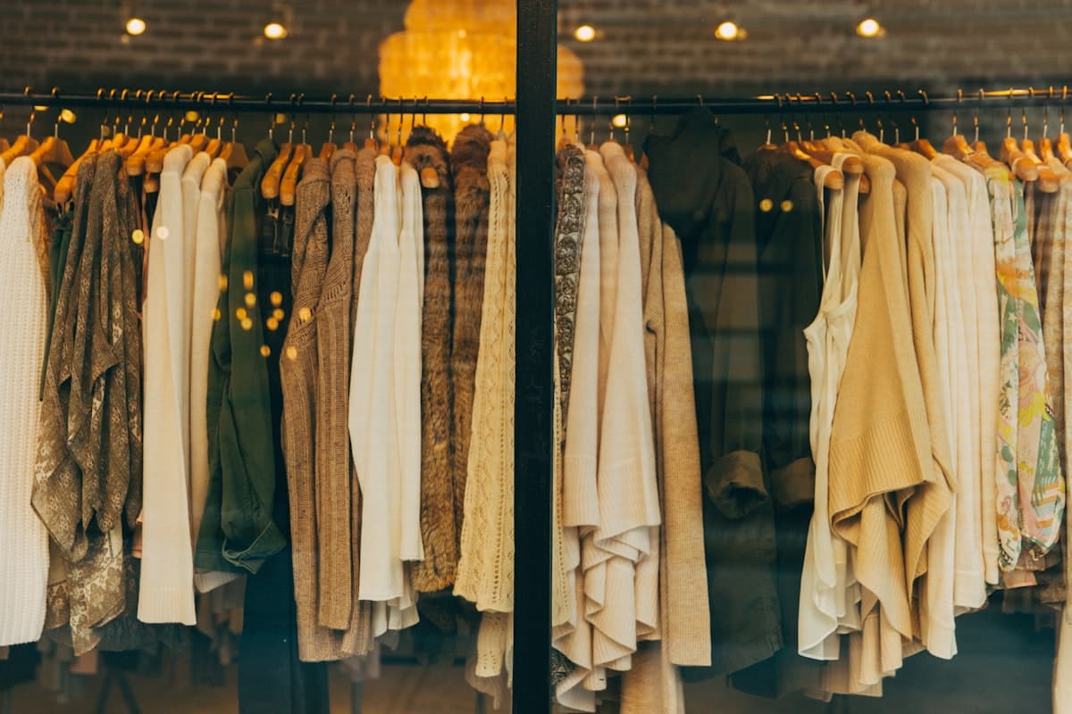 A curated rail of premium menswear pieces styled for a personal shopping brief