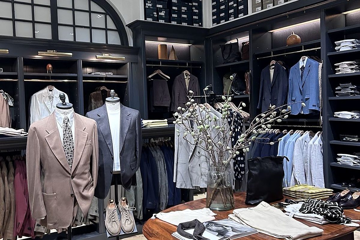A curated rail of premium menswear pieces styled for a personal shopping brief